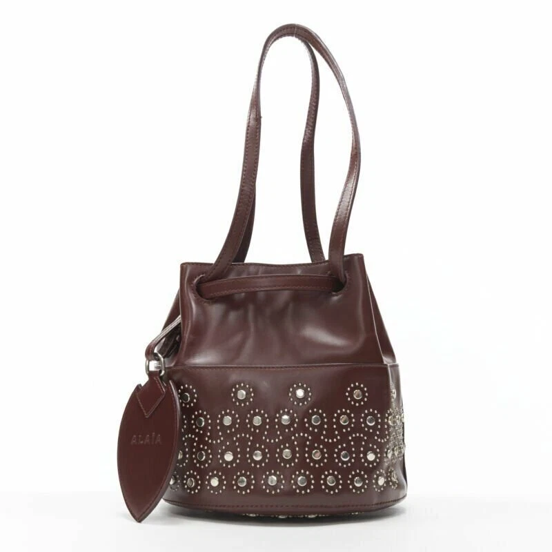ALAIA burgundy red geometric silver studded drawstring mirror charm bucket bag