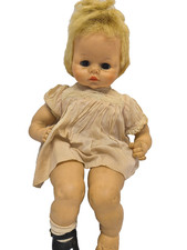 vintage creepy doll with black eyes missing a shoe