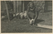 Young woman posing with piglet pigs antique arm photo