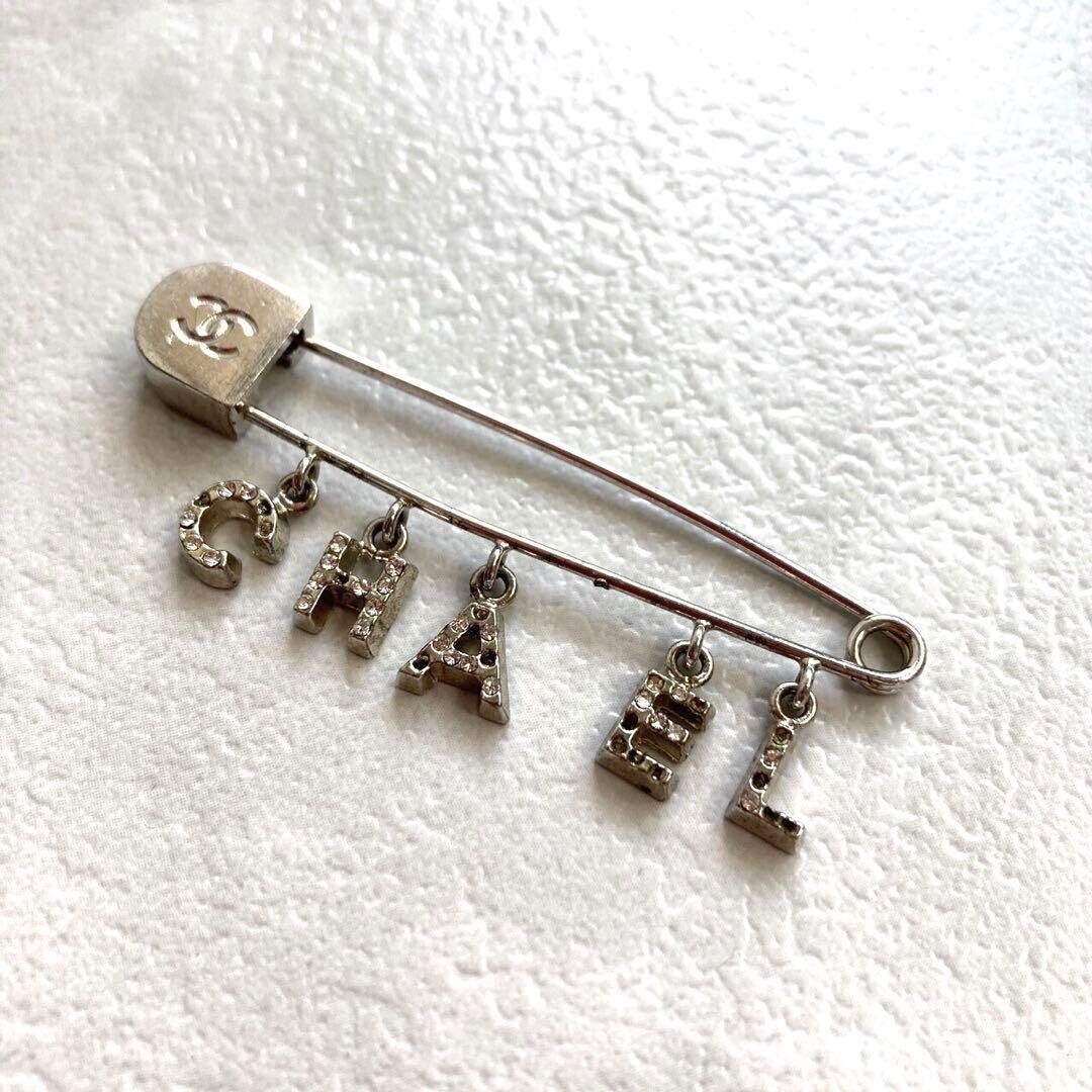 CHANEL Silver Plated Logos Swing Charm Rhinestone Pin Brooch CHANEL Silver Plated Logos Swing Charm Rhinestone Pin Brooch