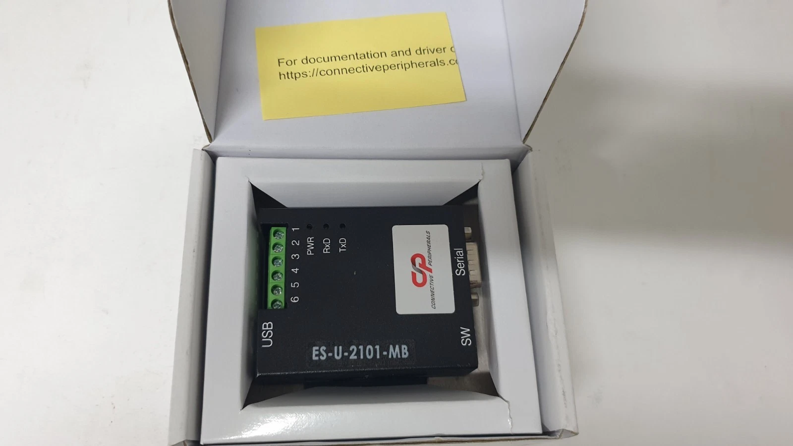 ES-U-2101-MB adapter in its open box with terminal block, LEDs and DB-9 port