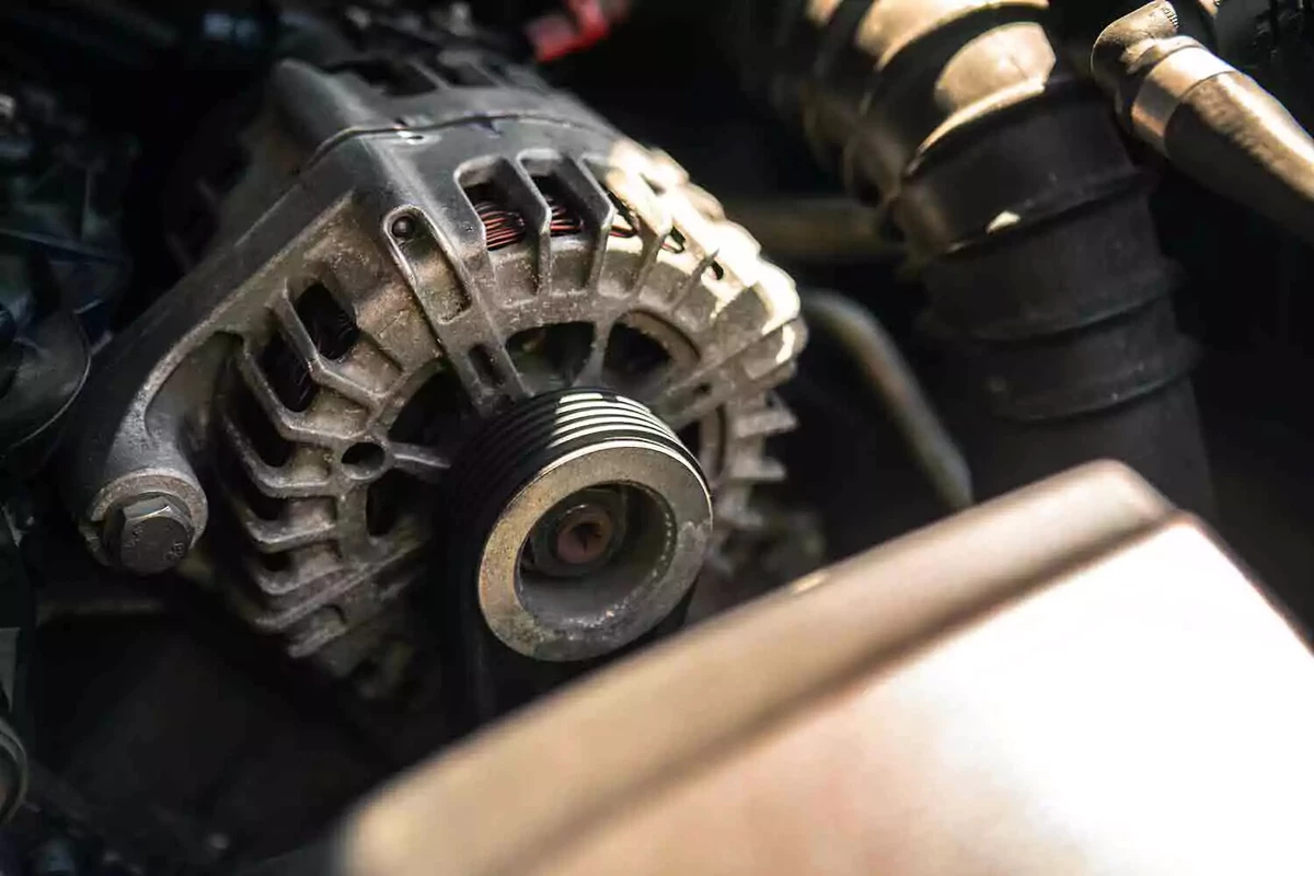 A weathered alternator on a dusty engine.