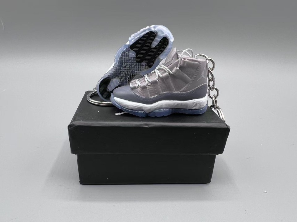 A miniature Jordan 11 sneaker keychain with an optional display box — sneakerhead culture distilled into a pocket-sized flex.