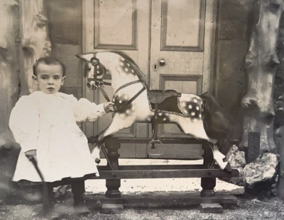 Frühe montierte Fotokarte Kind altes Schaukelpferd Spielzeughaus 1900er-1920er Jahre