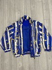 Women's blue and white striped COACO jacket with yellow golf print, long sleeves, and stand collar.