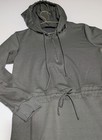 Olive women's hoodie with long sleeves, front zipper, elastic cuffs, and gathered waist, hanging on a wooden hanger.