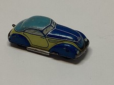 Cardo storico miniatura giocattolo in latta con molla