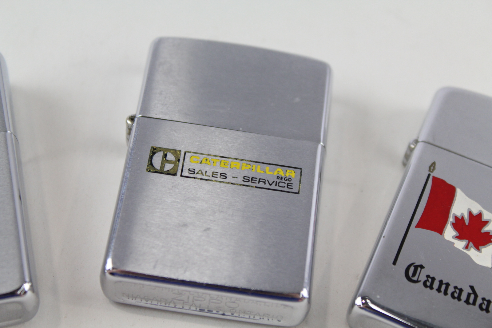 Zippo Lighters x 3 Inc. Canadian Caterpillar Ad, Canada 1978 & Golfer