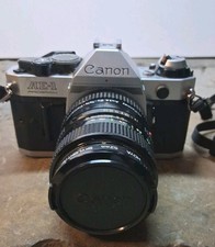 Pre Owned -Canon AE-1 Program 35mm SLR Film Camera w/ 52mm f/1.8 FD Lens
