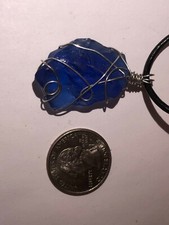 wire wrapped blue seaglass necklace on a cord