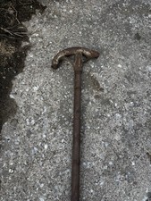 This is a vintage metal conduit bender, a tool used to bend electrical pipe