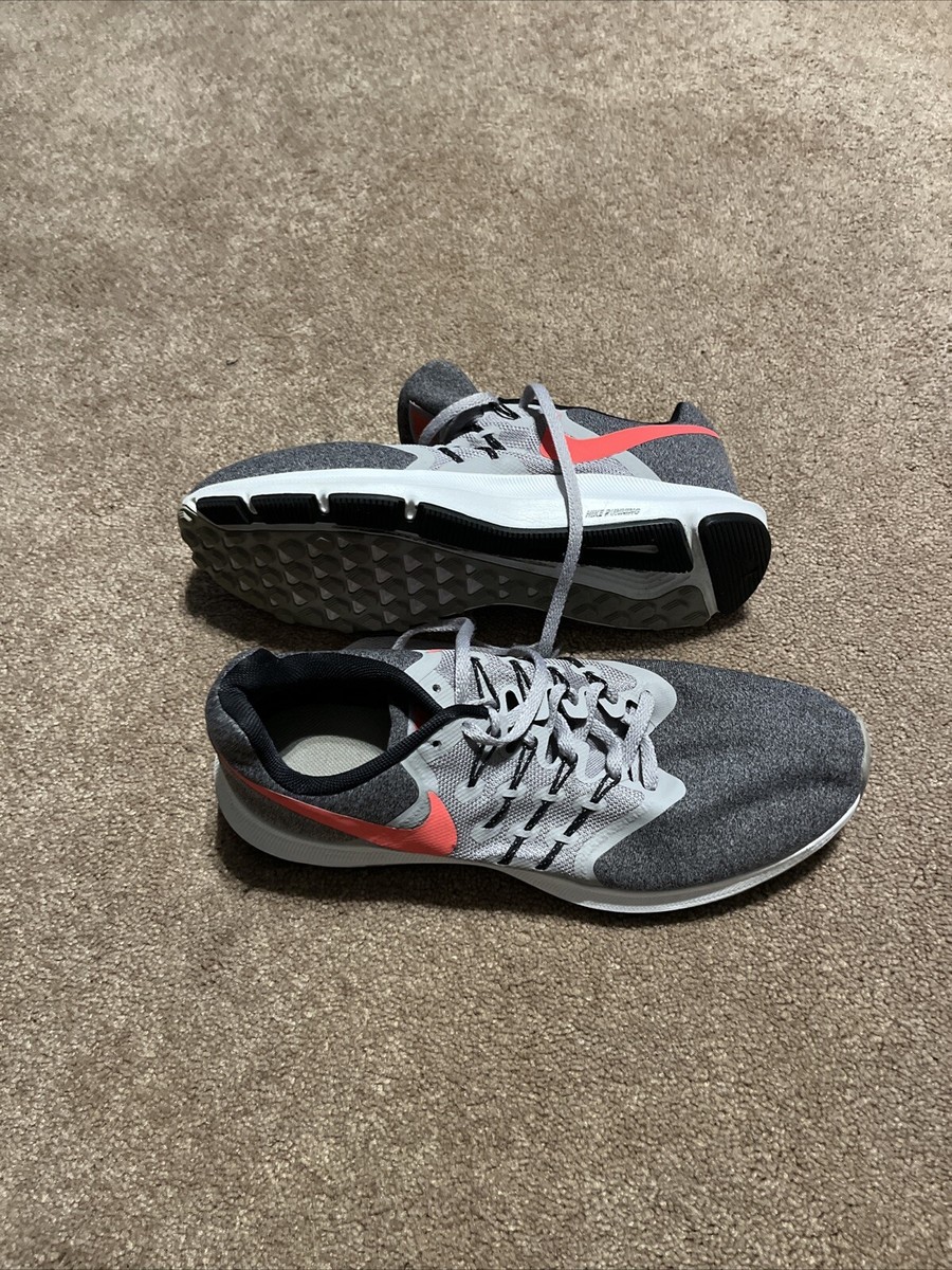gray nike shoes with red swoosh