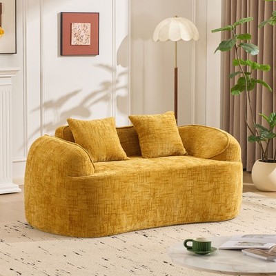 Yellow curved two - person compress  sofa. It has armrests on both sides, come