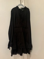 Stellah black long sleeve lace mini dress with a sinched waist.