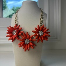 Orange/coral color statement necklace with rhinestone center