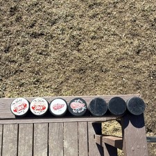 Detroit Red Wings Autographed Hockey Pucks Lot with Gordie Howe