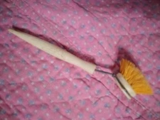 Ergo scrub brush. Yellow bristles. 9 3/4 inches long.