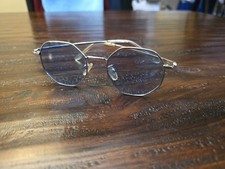 polygon-shaped metal-frame sunglasses with blue-tinted lenses