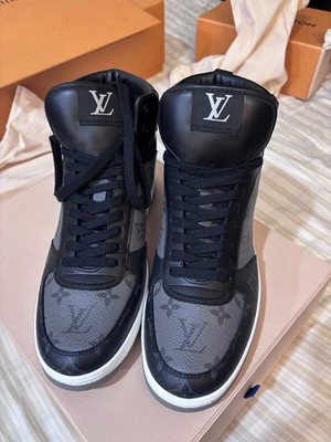 Louis Vuitton Men's Rivoli sneaker boots in black Monogram Eclipse canvas.