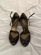 Anne Klein brand ankle strap heels feature a patent leather finish