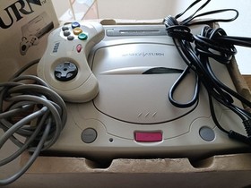 SEGA Saturn console with controller and 2 games
