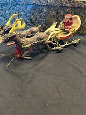 vintage cast iron Santa sleigh and reindeer pull toy 13 in long has damage