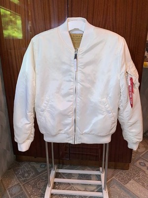 White Alpha Industries bomber jacket with a red ribbon