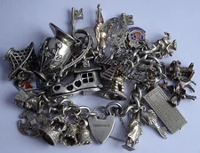 Vintage 102.9g solid silver charm bracelet,many curious silver charms inc moving