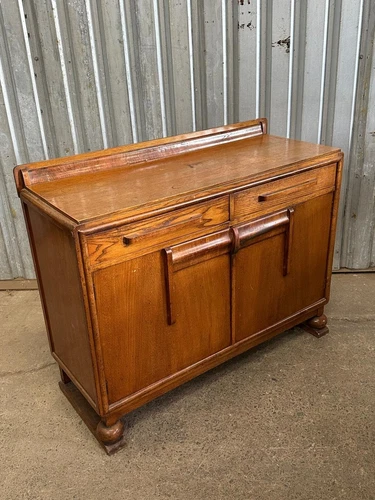 A 1930’s oak and mahogany mounted sideboard