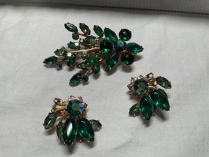 Vintage brooch and clip earrings set with green emerald colored rhinestones