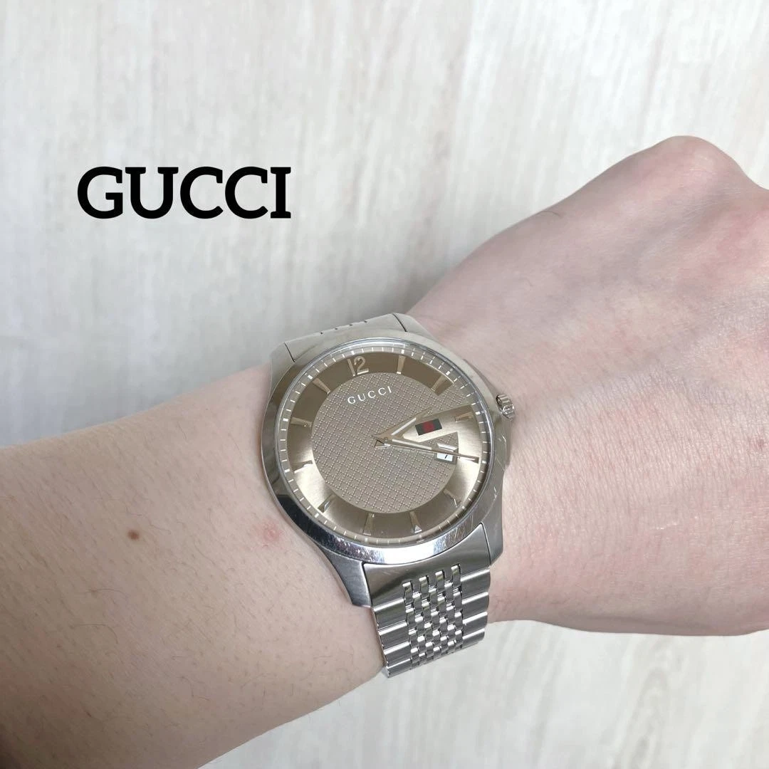 Montre Gucci G Timeless 42 mm cadran doré 126,3 date   état