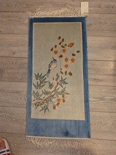 A Chinese Art Deco rug with birds and flowers on a mauve background 95x45cm