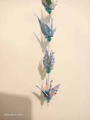 Pretty, colourful stringed origami paper cranes.