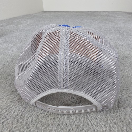 Gray US Air Force Indian Chief trucker hat with mesh back and silver mounting hardware on a gray carpet surface.