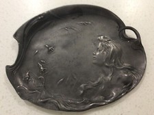 Antique Pewter Plate solid deeply embossed girl with flowers 8 inches long