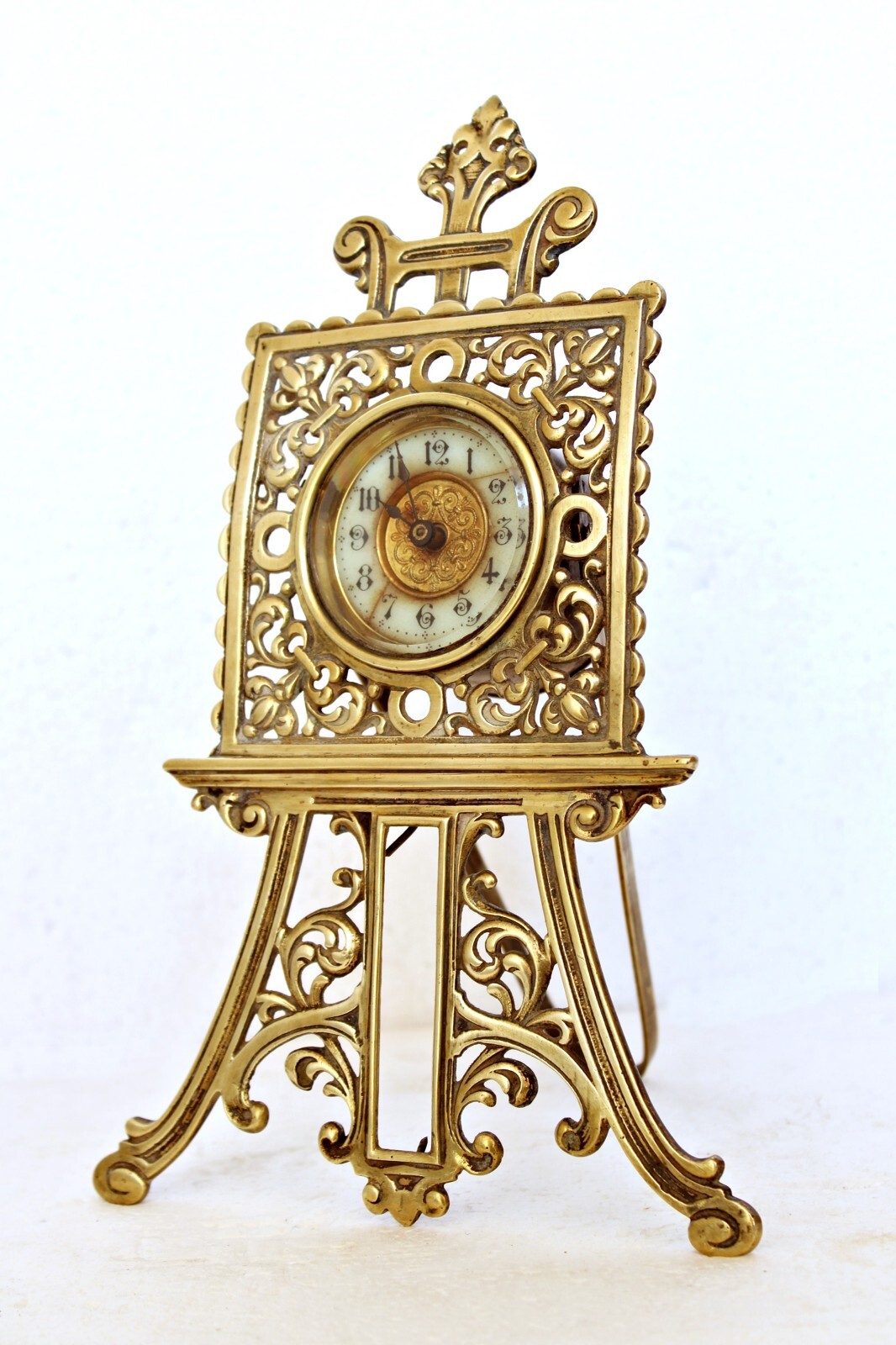 ANTIQUE BRASS STRUT CLOCK EASEL FORM, BRITISH UNITED CLOCK CO. DATED