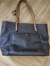 Michael Kors bag has make up stains inside .