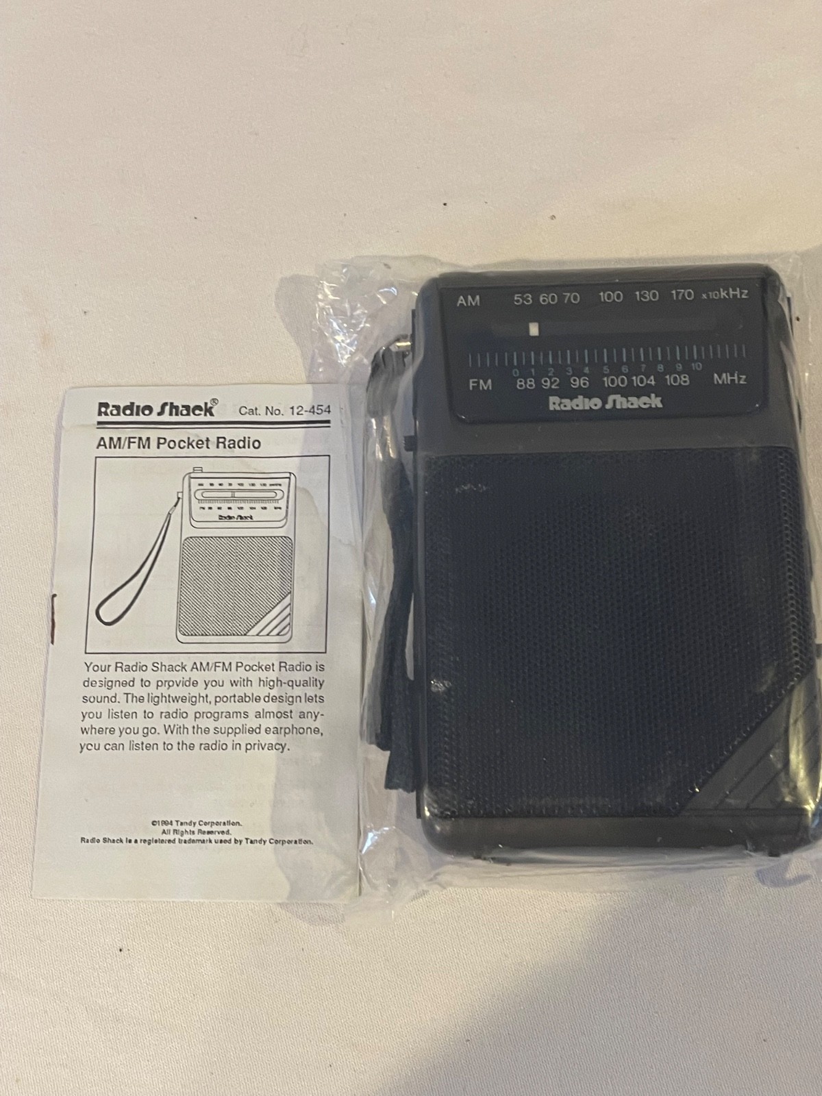 Radio Shack AM/FM pocket radio w/earphone: new