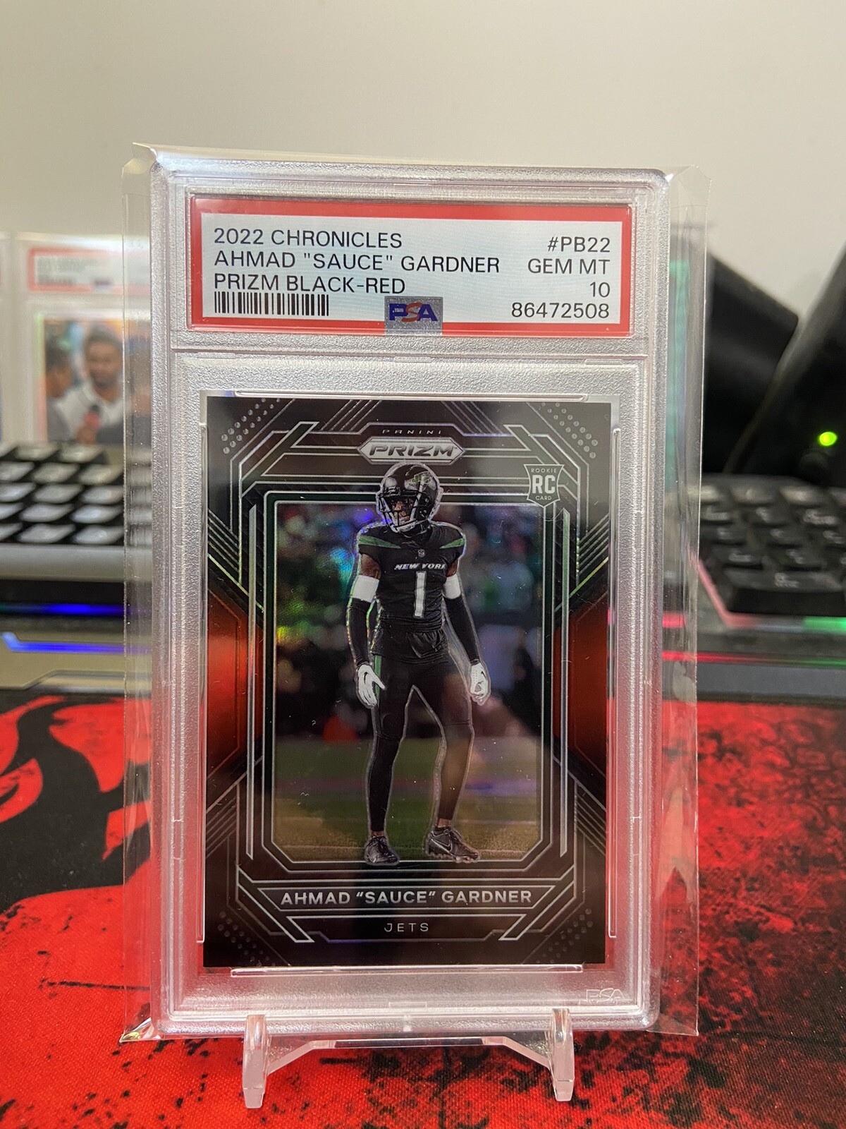 2022 Panini Chronicles Ahmad “Sauce” Gardner Prizm Black Red /99 PSA 10