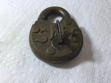 EARLY SMALL BRASS PADLOCK SAFE EMBEDED ON FACE COOD WORKING ORDER W KEY.