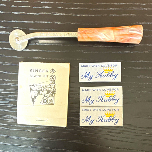 Singer sewing kit with clothing tags and Dritz tracking wheel