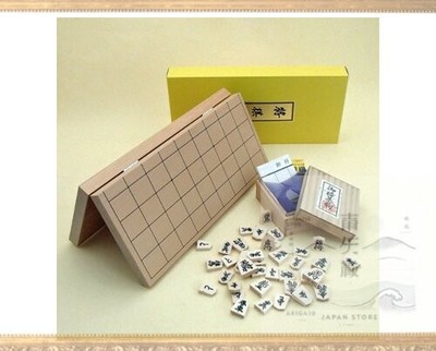 A portable shogi set with one Igo Lab original carved chess piece attached a