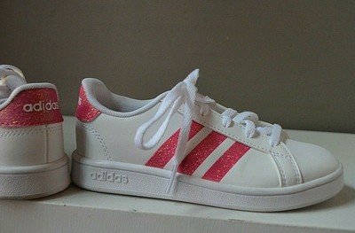 white adidas shoes with pink stripes