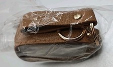 brown hand sanitizer holder keychain with a refillable travel-size Nip