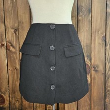 black mini skirt with button details.