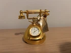 Vintage miniature quartz table clock in gold design, unverified collectible