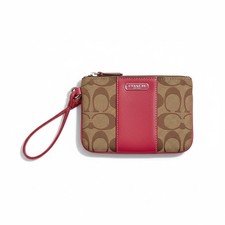 Coach Blocked Signature Canvas Small Wristlet Clutch in a pink tan color way.