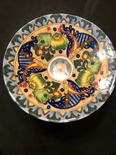 Decorative brightly painted bowl.  Beautiful multi-color design sure to brighten