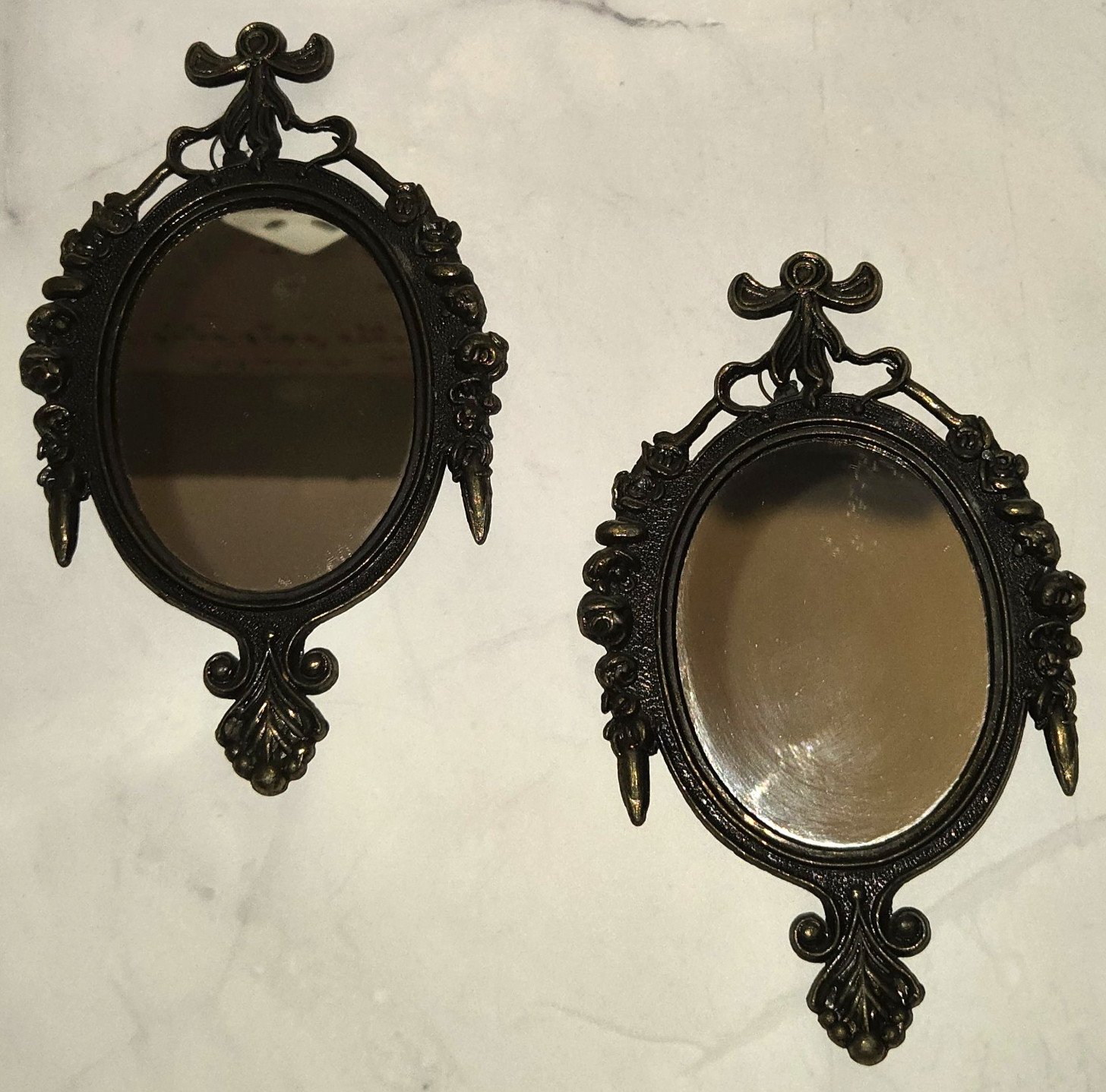Two small brass wall mirrors with ornate floral frame detailing, made in Italy.