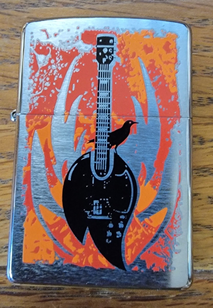 Zippo 24535 Flaming Guitar Brushed Chrome New in Box Retired Zippo 24535 Flaming Guitar Brushed Chrome New in Box Retired